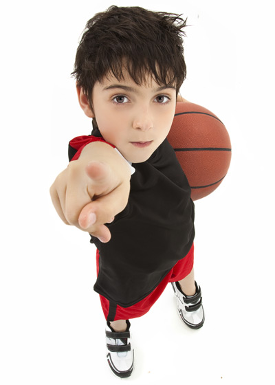 young boy holding basketball