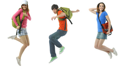 Teenagers jumping with backpacks on