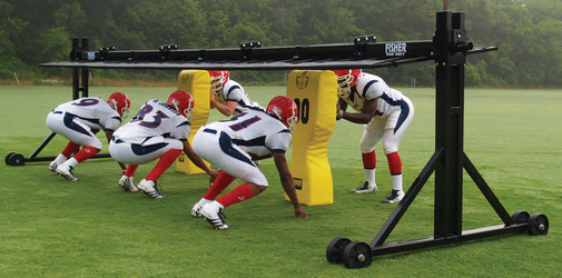 Players running drills through the Fisher Football Trap Chute