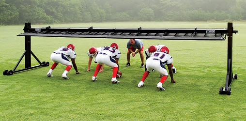 Coach and players doing drills using the Fisher Football Trap Chute