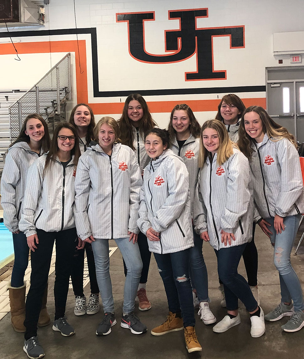 United Township Girls Swim Team modeling their team jackets